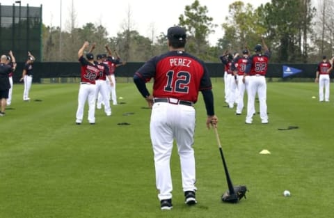 Feb 23, 2015; Lake Buena Vista, FL, USA; Atlanta Braves bullpen coach Eddie Perez (12) watches stretching exercises during spring training workouts at Champion Stadium. Mandatory Credit: Reinhold Matay-USA TODAY Sports