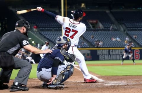 Aug 31, 2016; Atlanta, GA, USA; Atlanta Braves left fielder Matt Kemp (27) hits a sacrifice fly scoring third baseman Adonis Garcia (not pictured) as San Diego Padres catcher Derek Norris (3) is shown on the play in the eighth inning of their game at Turner Field. The Braves won 8-1. Mandatory Credit: Jason Getz-USA TODAY Sports