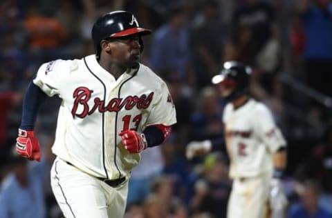 Sep 10, 2016; Atlanta, GA, USA; Atlanta Braves third baseman Adonis Garcia (13) runs to first on an RBI as shortstop Dansby Swanson (2) runs to home base for the walk-off win during the tenth inning against the New York Mets at Turner Field. Braves won 4-3. Mandatory Credit: Shanna Lockwood-USA TODAY Sports