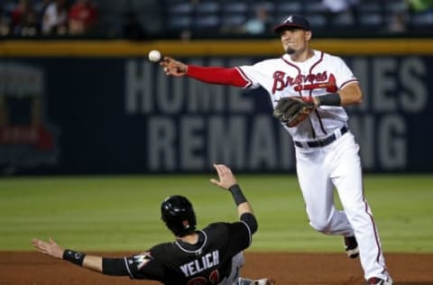 Sep 13, 2016; Atlanta, GA, USA; Atlanta Braves second baseman Jace Peterson (8) throws to first base on a double play as Miami Marlins left fielder Christian Yelich (21) is out at second base in the seventh inning of their game at Turner Field. Mandatory Credit: Jason Getz-USA TODAY Sports