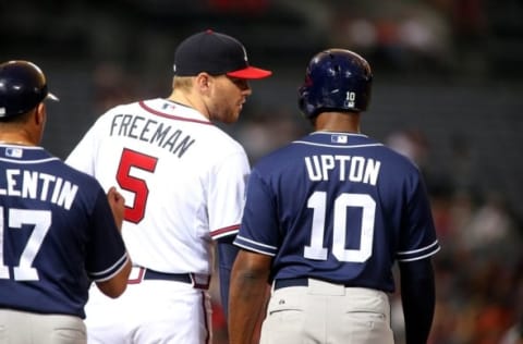 Jun 9, 2015; Atlanta, GA, USA; Atlanta Braves first baseman Freddie Freeman (5) talks with San Diego Padres Justin Upton (10) after a single by Upton in the third inning of their game at Turner Field. Mandatory Credit: Jason Getz-USA TODAY Sports