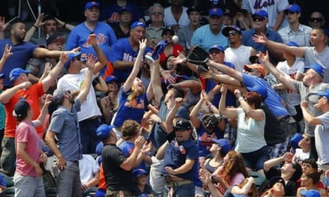 Jun 14, 2015; New York City, NY, USA; New York Mets fans attempt to catch a home run ball hit by Mets catcher Travis d