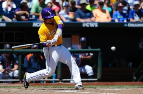 Jun 16, 2015; Omaha, NE, USA; LSU Tigers catcher Kade Scivicque (22) hits an RBI single in the third inning against the Cal State Fullerton Titans in the 2015 College World Series at TD Ameritrade Park. Mandatory Credit: Steven Branscombe-USA TODAY Sports