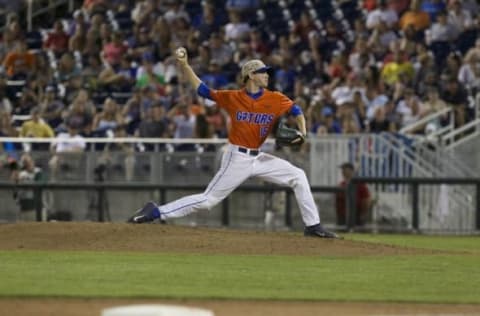 Jun 20, 2015; Omaha, NE, USA; Florida Gators pitcher Taylor Lewis (16) throws against the Virginia Cavaliers in the sixth inning at the 2015 College World Series at TD Ameritrade Park. Virginia won 5-4. Mandatory Credit: Bruce Thorson-USA TODAY Sports