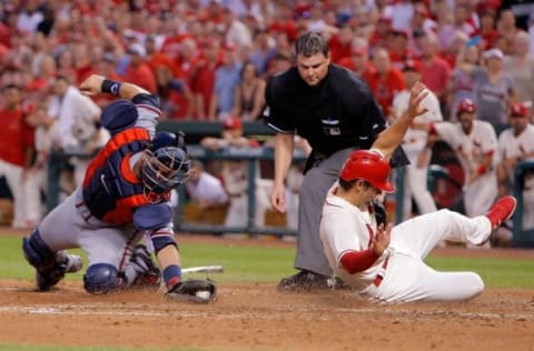 Jul 25, 2015; St. Louis, MO, USA; Atlanta Braves catcher A.J. Pierzynski (15) is unable to put the tag on St. Louis Cardinals shortstop Pete Kozma (38) as he slides home to score a run during the eighth inning of a baseball game at Busch Stadium. Mandatory Credit: Scott Kane-USA TODAY Sports