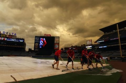 Sep 10, 2015; Atlanta, GA, USA; Grounds crew members work on the field during a rain delay before a game between the Atlanta Braves and New York Mets at Turner Field. Mandatory Credit: Brett Davis-USA TODAY Sports