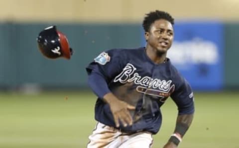 Mar 12, 2016; Lake Buena Vista, FL, USA; Atlanta Braves shortstop Ozzie Albies (87) loses his helmet whole running to third base during the sixth inning of a spring training baseball game against the Washington Nationals at Champion Stadium. Mandatory Credit: Reinhold Matay-USA TODAY Sports