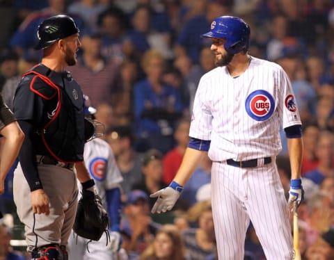 Jul 7, 2016; Chicago, IL, USA; Chicago Cubs starting pitcher Jason Hammel (39) talks to Atlanta Braves catcher Tyler Flowers (25)after he was hit by a pitch during the fifth inning at Wrigley Field. Mandatory Credit: Caylor Arnold-USA TODAY Sports