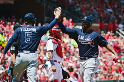 Aug 7, 2016; St. Louis, MO, USA; Atlanta Braves left fielder Matt Kemp (27) celebrates with first baseman Freddie Freeman (5) after scoring during the first inning against the St. Louis Cardinals at Busch Stadium. Mandatory Credit: Jeff Curry-USA TODAY Sports