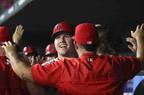 Sep 21, 2016; Arlington, TX, USA; Los Angeles Angels center fielder Mike Trout (27) celebrates with teammates after hitting a three run home run during the fifth inning against the Texas Rangers at Globe Life Park in Arlington. Mandatory Credit: Kevin Jairaj-USA TODAY Sports