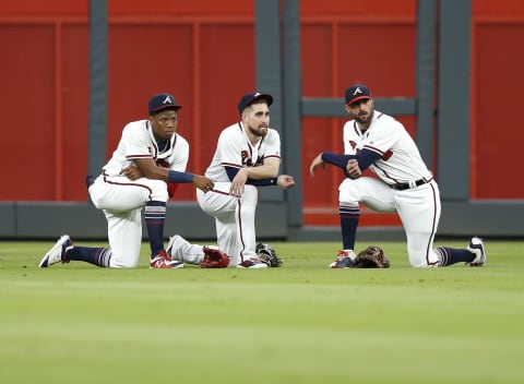 ATLANTA, GA – JULY 26: Outfielders (from left to right ) Ronald Accuna, Jr. #13, Ender Incciarte #11 and right fielder Nick Marckakis #22 of the Atlanta Braves kneel during a pitching change in the seventh inning during the game against the Los Angeles Dodgers at SunTrust Park on July 26, 2018 in Atlanta, Georgia. (Photo by Mike Zarrilli/Getty Images)