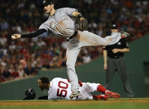 BOSTON, MA – AUGUST 29: JT Riddle #10 of the Miami Marlins turns a double play after tagging out base runner Mookie Betts #50 of the Boston Red Sox in the seventh inning at Fenway Park on August 29, 2018 in Boston, Massachusetts. (Photo by Jim Rogash/Getty Images)