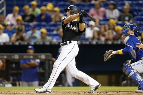 MIAMI, FL – SEPTEMBER 01: J.T. Realmuto #11 of the Miami Marlins hits a solo home run in the third inning against the Toronto Blue Jays at Marlins Park on September 1, 2018 in Miami, Florida. (Photo by Michael Reaves/Getty Images)