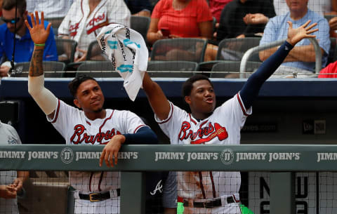 ATLANTA, GA – SEPTEMBER 05: Ronald Acuna Jr. #13 and Johan Camargo #17 of the Atlanta Braves reacts after a triple hit by Ozzie Albies #1 in the fifth inning against the Boston Red Sox at SunTrust Park on September 5, 2018 in Atlanta, Georgia. (Photo by Kevin C. Cox/Getty Images)