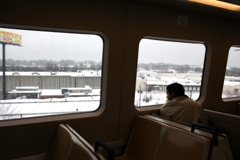 ATLANTA, GA – JANUARY 10: A passenger looks at the view from a Marta train after a snow storm on January 10, 2011 in Atlanta, Georgia.  A winter storm stretched across the Southeast as freezing rain and sleet followed on the heels of a heavy snow that blanketed the region. (Photo by Jessica McGowan/Getty Images)