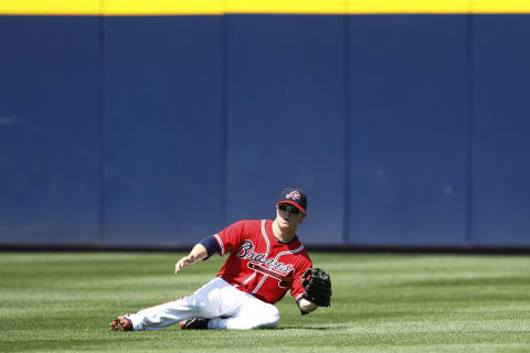 ATLANTA, GA – APRIL 10: Nate McLouth #13 of the Atlanta Braves makes a sliding catch in the outfield against the Philadelphia Phillies at Turner Field on April 10, 2011 in Atlanta, Georgia. The Phillies won 3-0. (Photo by Joe Robbins/Getty Images)