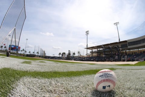 A baseball sits on the field before a spring training baseball game. (Photo by Rich Schultz/Getty Images)