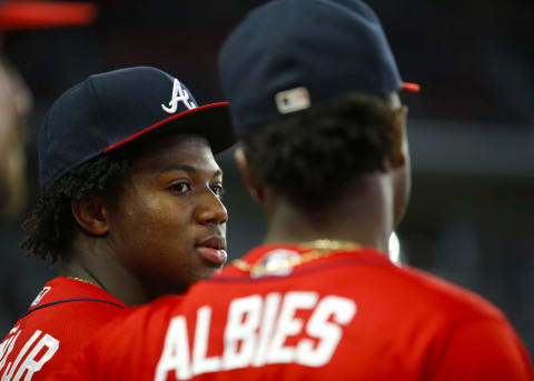 Ronald Acuna Jr. #13 of the Atlanta Braves speaks with Ozzie Albies #1. (Photo by Todd Kirkland/Getty Images)
