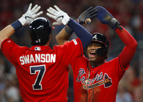 ATLANTA, GA – MAY 17: Ronald Acuna Jr. #13 of the Atlanta Braves reacts with Dansby Swanson #7 after Swanson’s three run home run in the sixth inning of an MLB game against the Milwaukee Brewers at SunTrust Park on May 17, 2019 in Atlanta, Georgia. (Photo by Todd Kirkland/Getty Images)