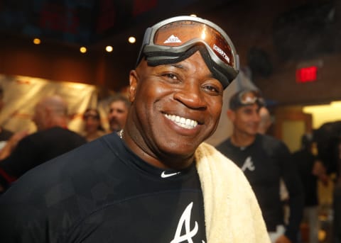 ATLANTA, GA – SEP 20: First Base Coach Eric  Young of the Atlanta Braves celebrates with a cigar in the clubhouse at the conclusion of an MLB game against the San Francisco Giants in which they clinched the N.L. East at SunTrust Park on September 20, 2019 in Atlanta, Georgia. (Photo by Todd Kirkland/Getty Images)