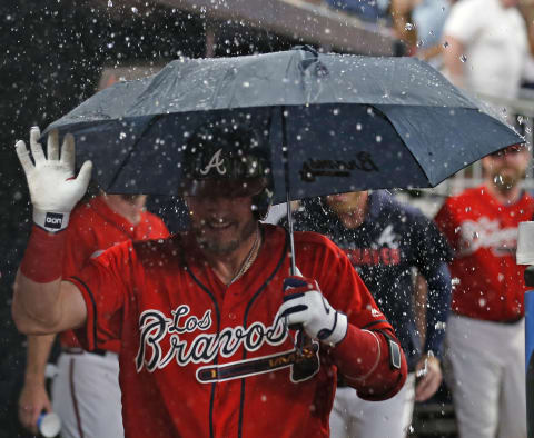 ATLANTA, GEORGIA – SEPTEMBER 06: Third baseman Josh Donaldson #20 of the Atlanta Braves celebrates in the dugout with an umbrella after hitting a 2-run home run in the seventh inning during the game against the Washington Nationals at SunTrust Park on September 06, 2019 in Atlanta, Georgia. (Photo by Mike Zarrilli/Getty Images)