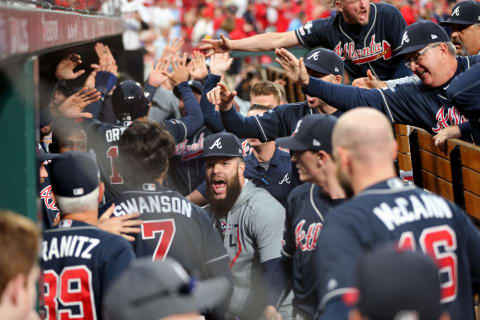 ST LOUIS, MISSOURI – OCTOBER 06: Dansby  Swanson #7 of the Atlanta Braves is congratulated by his teammates in the dugout after hitting an RBI double and scoring a run during the ninth inning against the St. Louis Cardinals in game three of the National League Division Series at Busch Stadium on October 06, 2019 in St Louis, Missouri. (Photo by Jamie Squire/Getty Images)