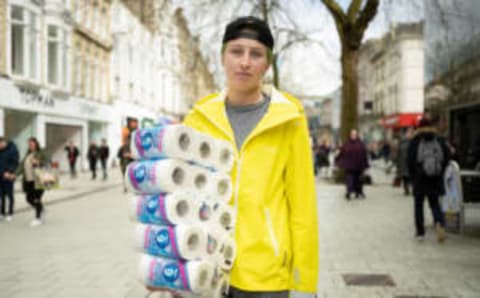 CARDIFF, UK – MARCH 14: A woman poses for a photograph holding packets of toilet paper. (Photo by Matthew Horwood/Getty Images)