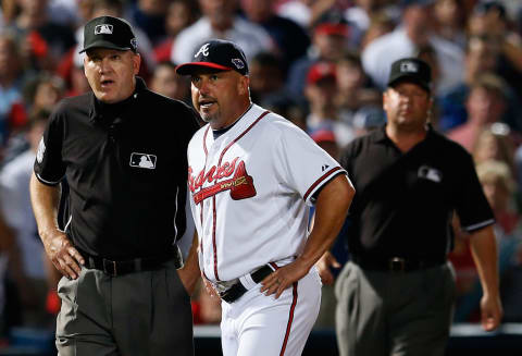 ATLANTA, GA – OCTOBER 05: Manager Fredi Gonzalez #33 of the Atlanta Braves argues an infield fly ruling in the eighth inning with third base umpire Jeff Nelson and left field umpire Sam Holbrook while taking on the St. Louis Cardinals during the National League Wild Card playoff game at Turner Field on October 5, 2012 in Atlanta, Georgia. (Photo by Kevin C. Cox/Getty Images)