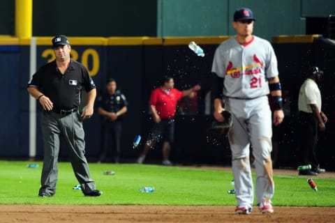 ATLANTA, GA – OCTOBER 05: Umpire Rob Drake reacts after bottles and cups are thrown on the field by fans after the home fans disagree with an infield fly ruling on a ball hit by Andrelton Simmons #19 of the Atlanta Braves in the eighth inning while taking on the St. Louis Cardinals during the National League Wild Card playoff game at Turner Field on October 5, 2012 in Atlanta, Georgia. (Photo by Scott Cunningham/Getty Images)