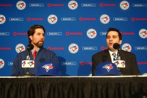 TORONTO, CANADA – JANUARY 8: R.A.  Dickey #43 (L) of the Toronto Blue Jays is introduced at a press conference by general manager Alex Anthopoulos at Rogers Centre on January 8, 2013 in Toronto, Ontario, Canada. (Photo by Tom Szczerbowski/Getty Images)