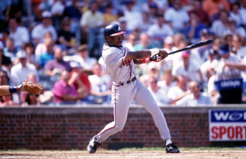 28 Aug 1995: Batter Marquis Grissom of the Atlanta Braves connects with a pitch during a 7-5 loss to the Chicago Cubs at Wrigley Field in Chicago, Illinois.