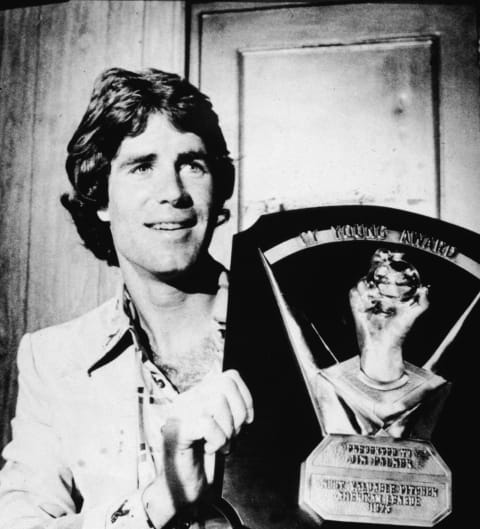 American baseball player Jim Palmer holds up his Cy Young award, one of three he won over the course of his career, 1975. (Photo by Hulton archive/Getty Images)