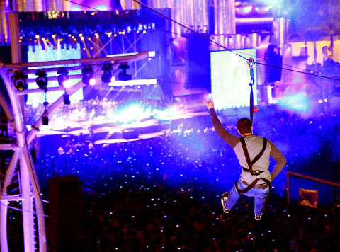 LAS VEGAS, NV – MAY 09: Festival-goer rocks out while zip-lining over Metallica performance onstage during Rock in Rio USA at the MGM Resorts Festival Grounds on May 9, 2015 in Las Vegas, Nevada. (Photo by Christopher Polk/Getty Images)