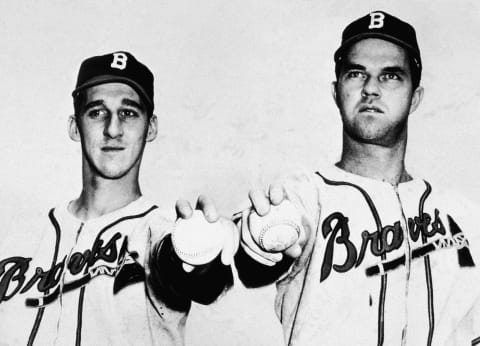 Boston Braves pitchers Warren Spahn (1921 – 2003) (left) and Johnny Sain wear their uniforms and hold baseballs out in front of them, October 15, 1948. (Photo by Hulton Archive Getty Images)