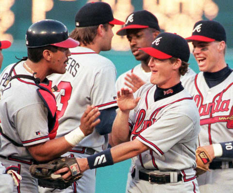 Atlanta Braves Jeff Blauser is congratulated by catcher Javy Lopez.  AFP PHOTO Rhona WISE (Photo credit RHONA WISE/AFP via Getty Images)