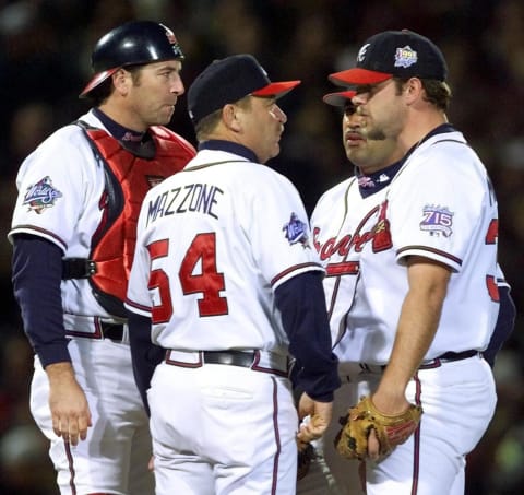 Kevin Millwood of the Atlanta Braves is visited on the mound by pitching coach Leo Mazzone . (Photo credit by JEFF HAYNES/AFP via Getty Images)