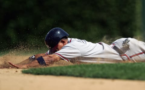 CHICAGO – AUGUST 24: Rafael Furrcal #1 of the Atlanta Braves slides head first during the game with the Chicago Cubs on August 24, 2005 at Wrigley Field in Chicago, Illinois. The Braves defeated the Cubs 3-1. (Photo by Jonathan Daniel/Getty Images)