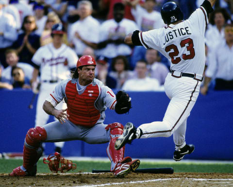 Darren Daulton of the Phillies tries to tag David Justice of the Atlanta Braves during NLCS Game 3 in 1993. (Photo by Ronald C. Modra/Getty Images)