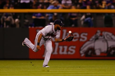 DENVER, CO – AUGUST 16: Left fielder Danny Sanntana #23 of the Atlanta Braves makes a juggling catch for an out in the fourth inning against the Atlanta Braves at Coors Field on August 16, 2017 in Denver, Colorado. (Photo by Justin Edmonds/Getty Images)