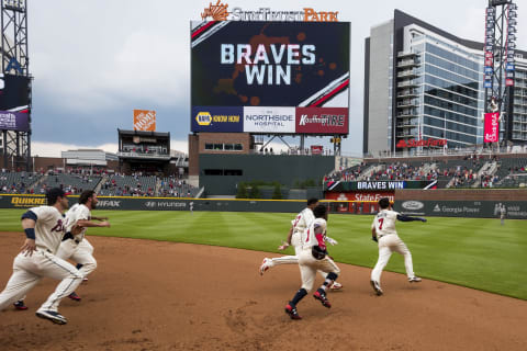 The Atlanta Braves start to celebrate another dramatic win. (Photo by Logan Riely/Beam Imagination/Atlanta Braves/Getty Images)