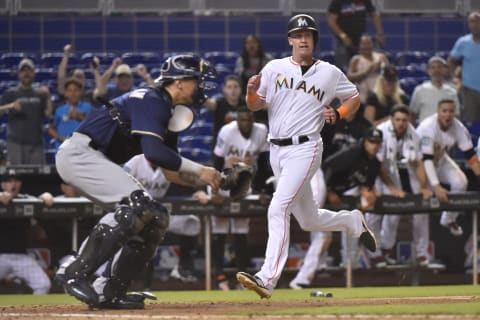 MIAMI, FL – JULY 11: Garrett Co oper #30 of the Miami Marlins scores the game winning run in the twelfth inning against the Milwaukee Brewers at Marlins Park on July 11, 2018 in Miami, Florida. (Photo by Eric Espada/Getty Images)