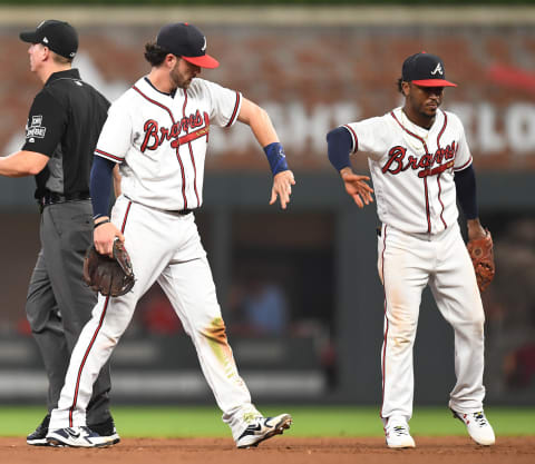 ATLANTA, GA – July 27: Dansby Swanson #7 (L) of the Atlanta Braves is congratulated by Ozzie Albies #1 after starting an eighth-inning double play against the Los Angeles Dodgers at SunTrust Park on July 27, 2018, in Atlanta, Georgia. (Photo by Scott Cunningham/Getty Images)