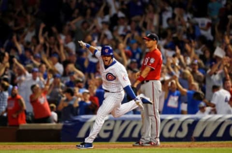 CHICAGO, IL – AUGUST 12: David Bote #13 of the Chicago Cubs celebrates his walk-off grand slam as Ryan Zimmerman #11 of the Washington Nationals looks on at Wrigley Field on August 12, 2018 in Chicago, Illinois. The Chicago Cubs won 4-3. (Photo by Jon Durr/Getty Images)