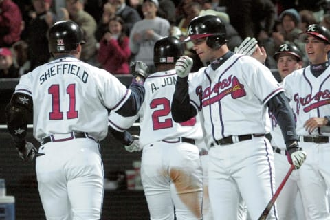 Javy Lopez congratulates Gary Sheffield after one of his Atlanta Braves homers. (Photo credit STEVE SCHAEFER/AFP via Getty Images)