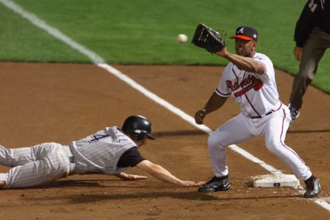 ATLANTA – October 19: First Baseman Julio Franco #41 of the Atlanta Braves looks to catch the ball as second baseman Craig Counsell #4 of the Arizona Diamondbacks dives headfirst back to the bag during game three of the National League Championship Series on October 19, 2001. (Photo by Andy Lyons/Getty Images)