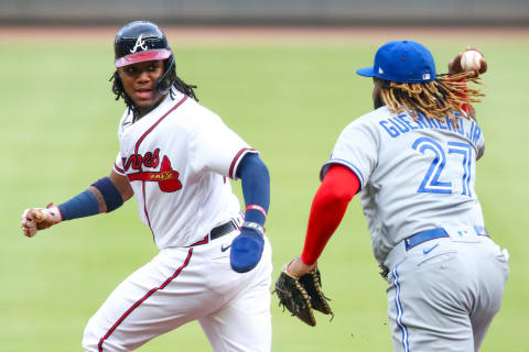 Ronald Acuna Jr. #13 of the Atlanta Braves is tagged out by Vladimir Guerrero Jr. #27 of the Toronto Blue Jays. (Photo by Carmen Mandato/Getty Images)