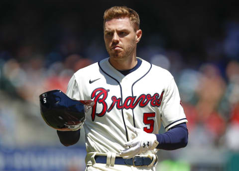 Atlanta Braves Freddie Freeman… with hat in hand? (Photo by Todd Kirkland/Getty Images)