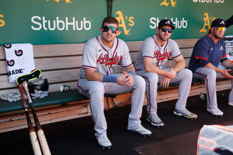 Austin Riley and Dylan Lee of the Atlanta Braves look on from the dugout before the game against the Oakland Athletics. (Photo by Lachlan Cunningham/Getty Images).