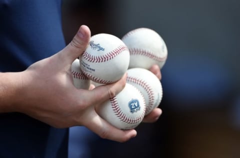 PHOENIX, AZ – FEBRUARY 28: New baseballs are delivered to the home plate umpire prior to a game between the Milwaukee Brewers and the Kansas City Royals at Maryvale Baseball Park on February 28, 2017 in Phoenix, Arizona. (Photo by Norm Hall/Getty Images)