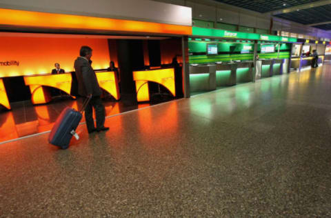 FRANKFURT AM MAIN, GERMANY – JULY 22: A traveller walks in front of car rental counters at Frankfurt airport on July 22, 2008 in Frankfurt, Germany. (Photo by Ralph Orlowski/Getty Images)